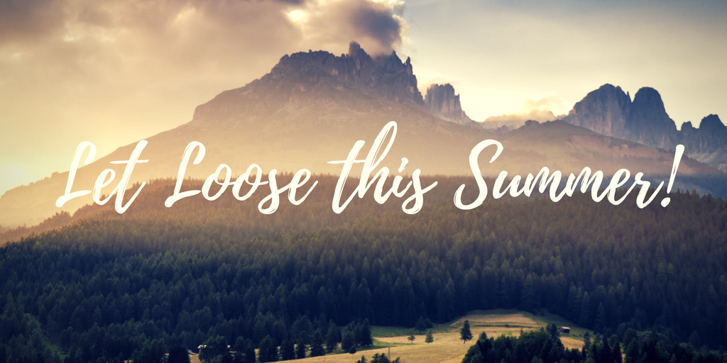 Summer sunlit mountains over forested meadow