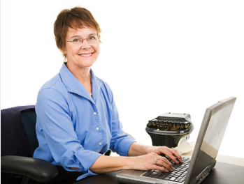 Smiling woman typing on laptop with typewriter