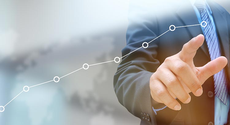 Businessman pointing at rising line graph