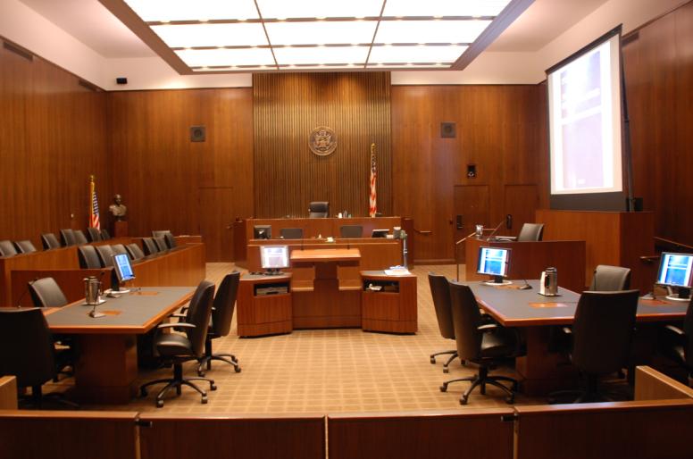 Empty courtroom with judge's bench and monitors
