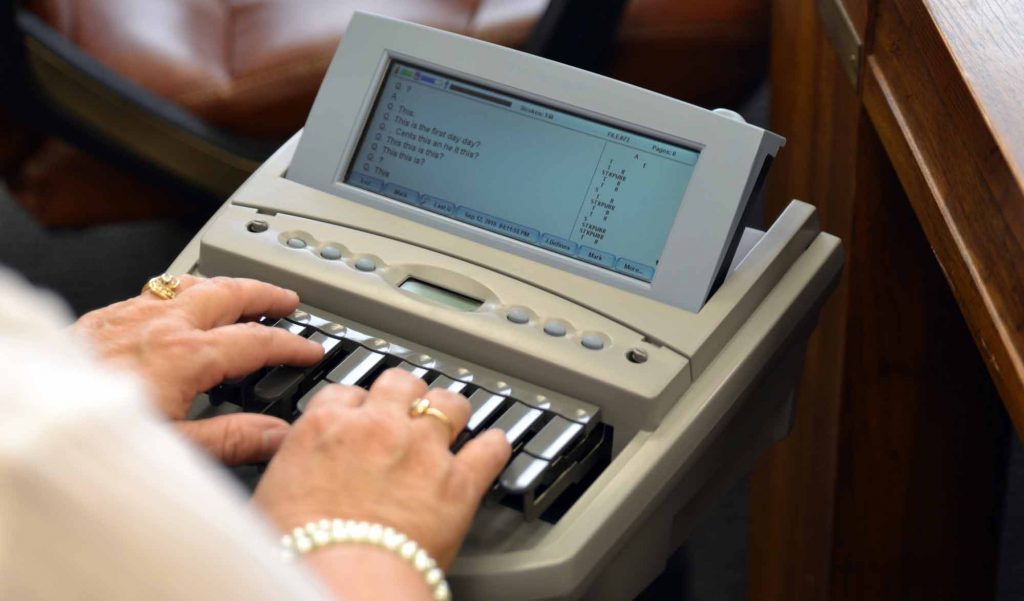 Hands typing on a braille note-taking device